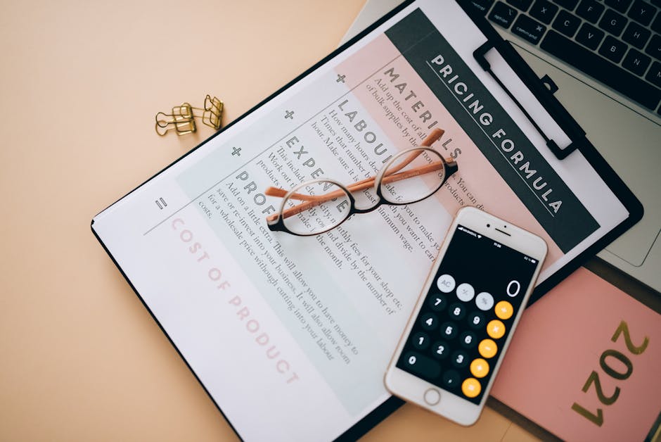 A close-up view of a digital pricing form displayed on a paper tablet featuring sections labeled 'Materials', 'Labour', 'Expertise', and 'Provide', with a pair of round, black-framed eyeglasses restin